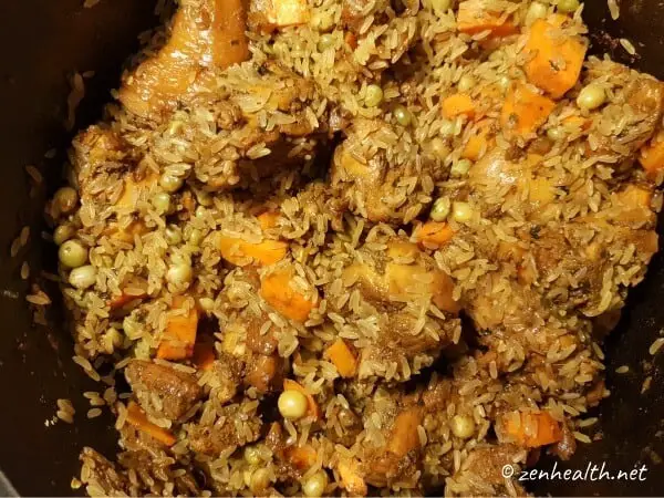 Adding rice and veggies to stewed chicken