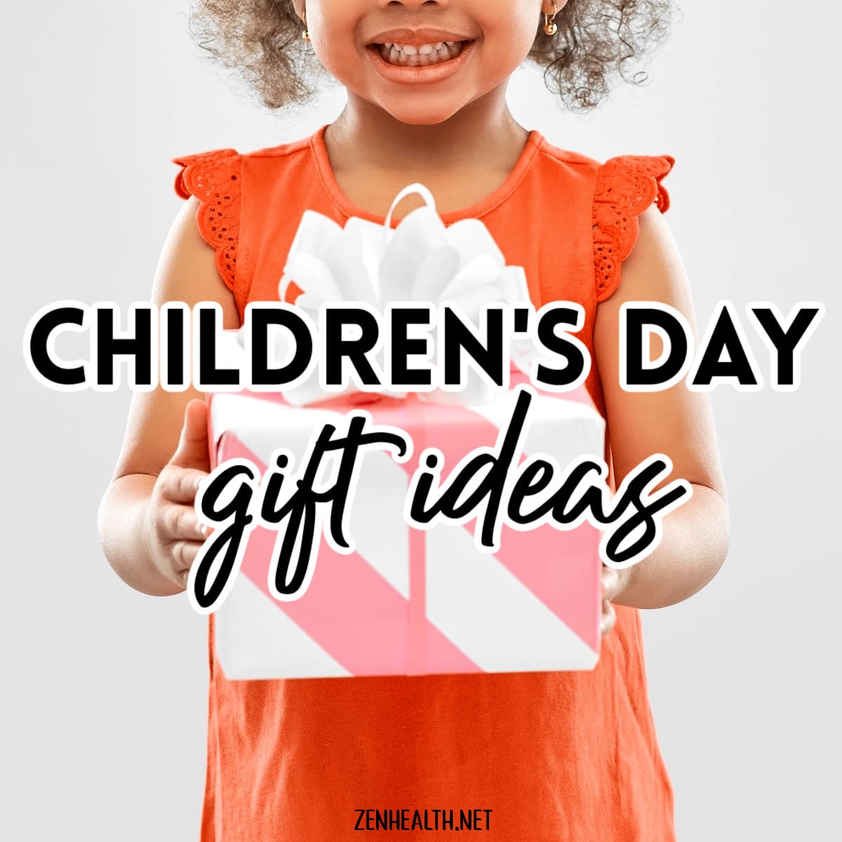 children's day gift ideas text overlay on a photo of a girl wearing an orange shirt holding a pink and white stripped gift