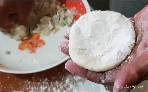 flattened dough ball with flour