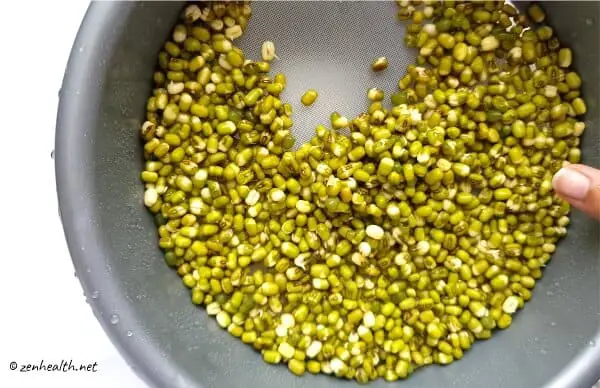 Soaked mung beans in a colander